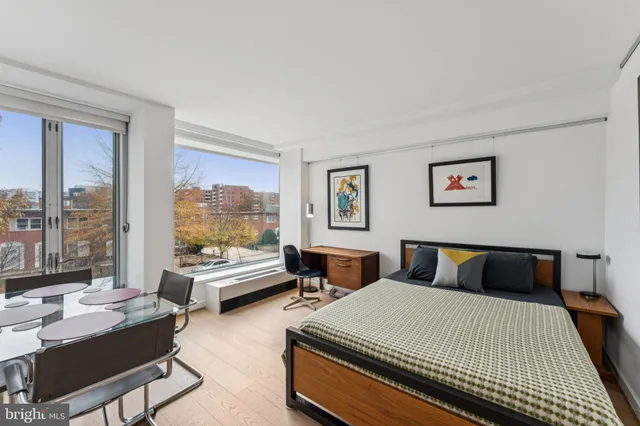 a bedroom with a bed a table and chair