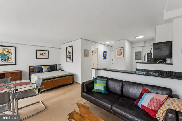 a kitchen with stainless steel appliances kitchen island granite countertop a dining table and chairs