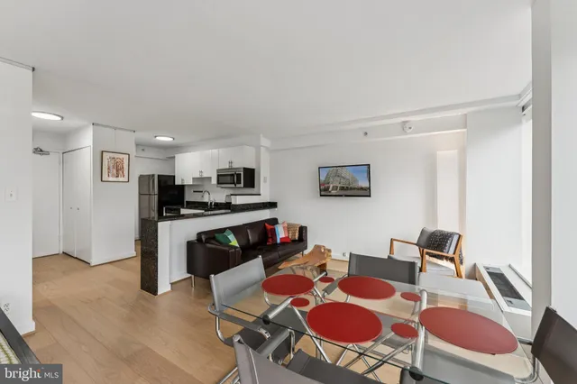 a kitchen with stainless steel appliances granite countertop a refrigerator a stove top oven a sink and dishwasher