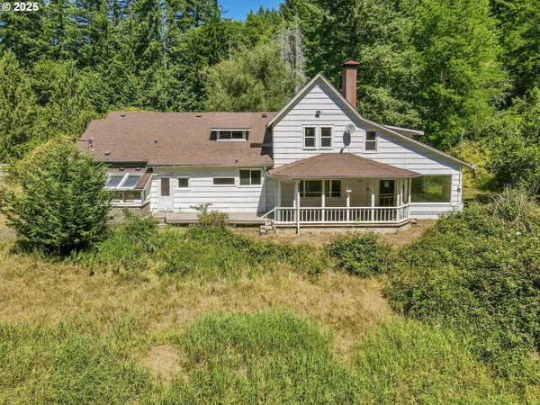 a view of a house with a yard and sitting area