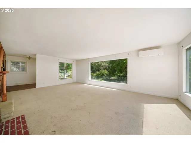 a view of a big room with windows and chandelier