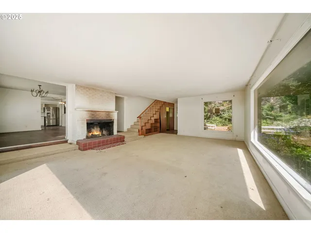 a view of an empty room with a fireplace