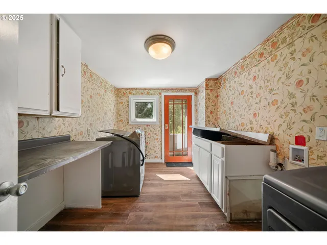 a kitchen with a sink and a stove top oven