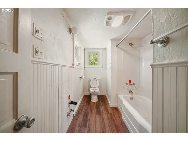 a bathroom with a bathtub and a shower