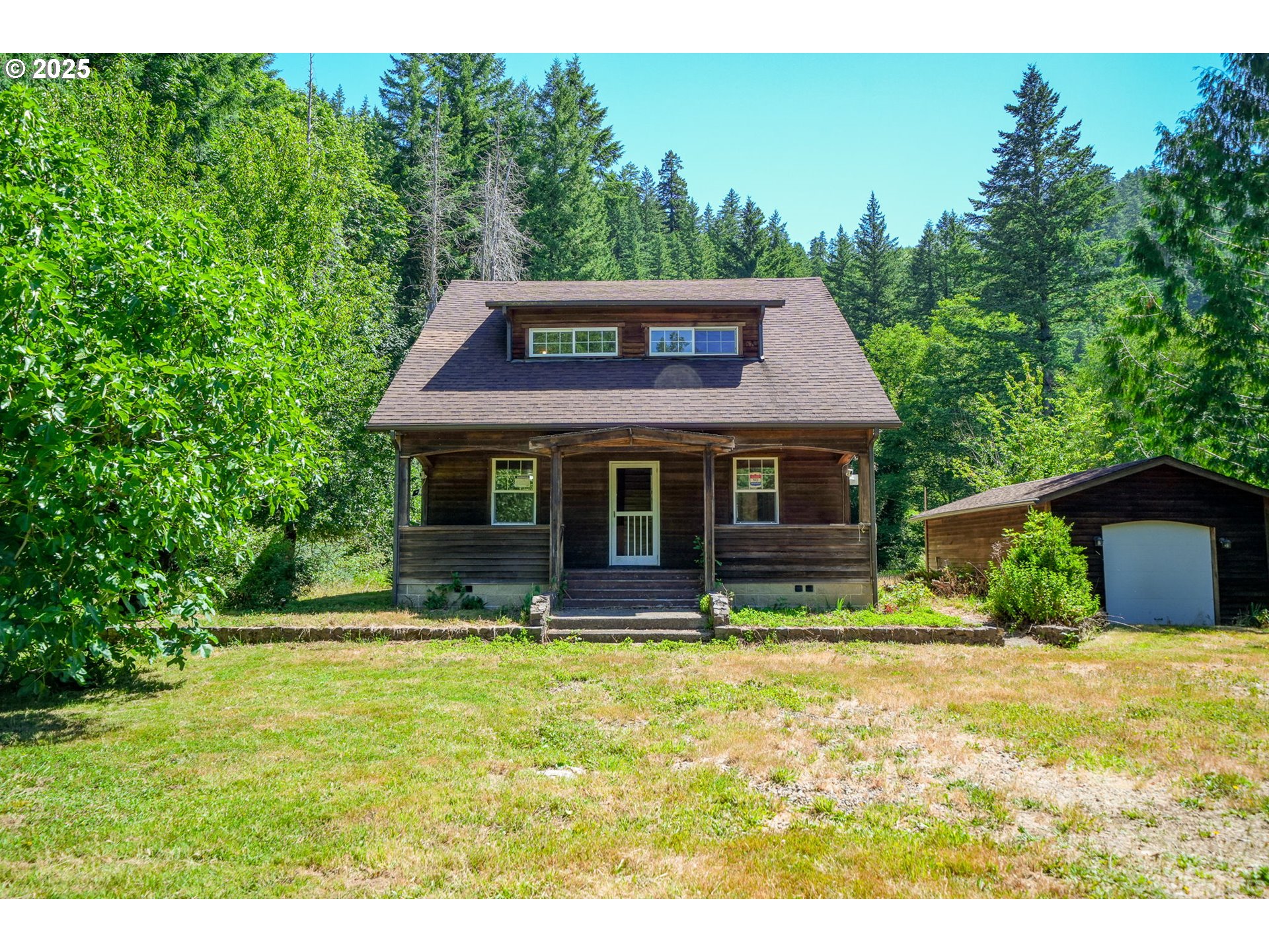 90450 Deadwood Creek Road Deadwood, OR 97430 - Photo 34 of 47 a front view of house with yard and trees in the background