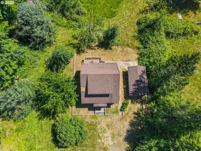 an aerial view of a house with a yard basket ball court and outdoor seating