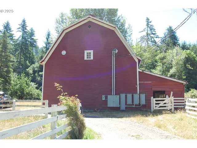 a backyard of a house with a yard and outdoor seating