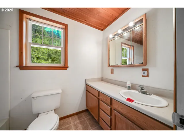 a bathroom with a sink toilet and mirror