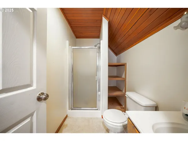 a bathroom with a toilet and a shower