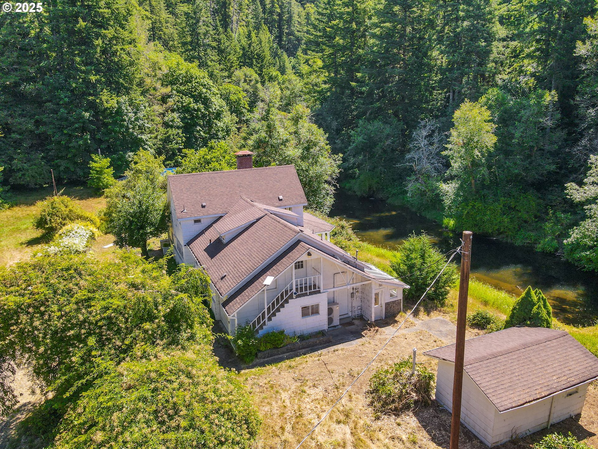 90450 Deadwood Creek Road Deadwood, OR 97430 - Photo 6 of 47 an aerial view of a house with a big yard and large trees