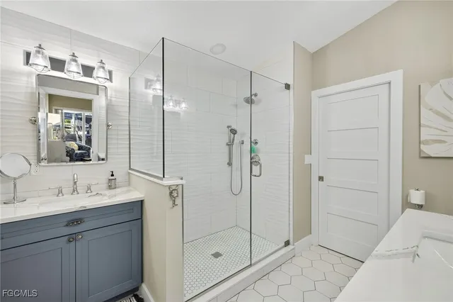 a bathroom with a shower sink and mirror