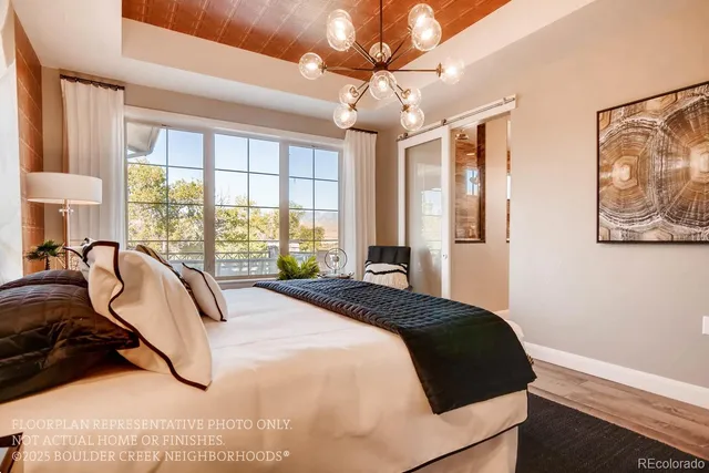a bedroom with a large bed and a chandelier