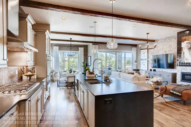 a kitchen with counter top space a sink stove and wooden floor