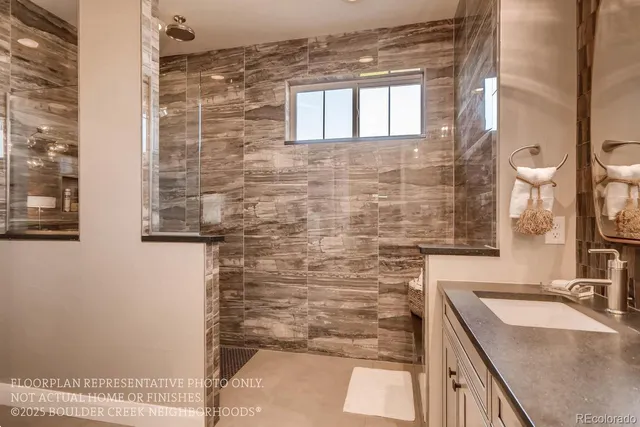 a bathroom with a granite countertop sink a vanity and a shower