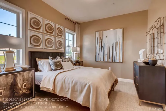 a bedroom with a bed and two windows