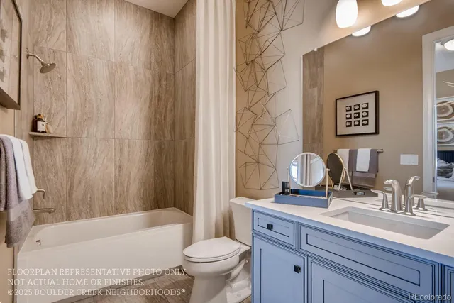 a bathroom with a sink a toilet a mirror a bathtub and shower