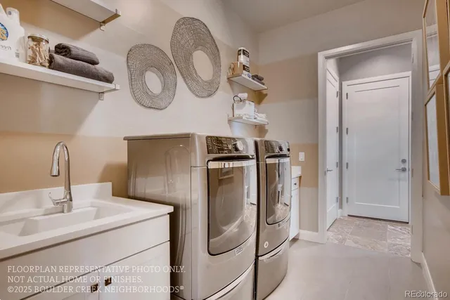 a kitchen with stainless steel appliances granite countertop a sink and a refrigerator