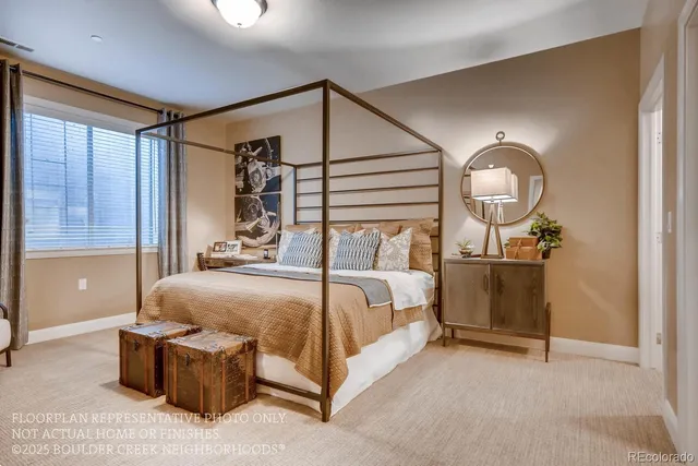 a bedroom with a bed lamp closet and large window