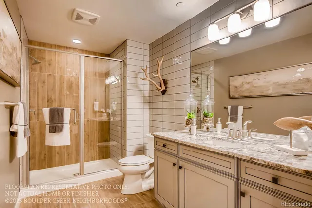 a bathroom with a granite countertop sink a toilet a mirror and shower