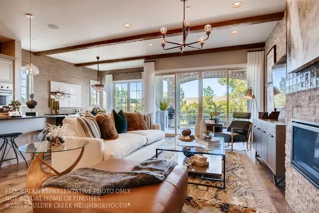 a living room with furniture fireplace and a large window