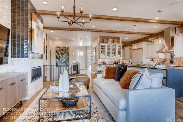 a living room with furniture and a view of kitchen