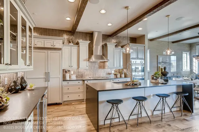 a kitchen with stainless steel appliances kitchen island granite countertop a table chairs sink and cabinets