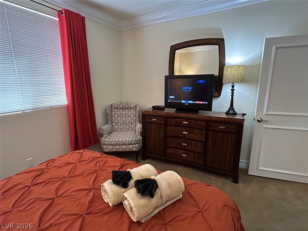 210 East Flamingo Road, Unit 137 Las Vegas, NV 89169 - Photo 19 of 32 Well-lit and functional, this bedroom offers comfort and a private space for relaxation.