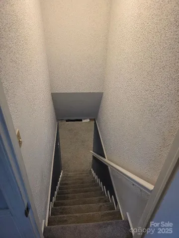 a kitchen with stainless steel appliances a refrigerator and wooden floor