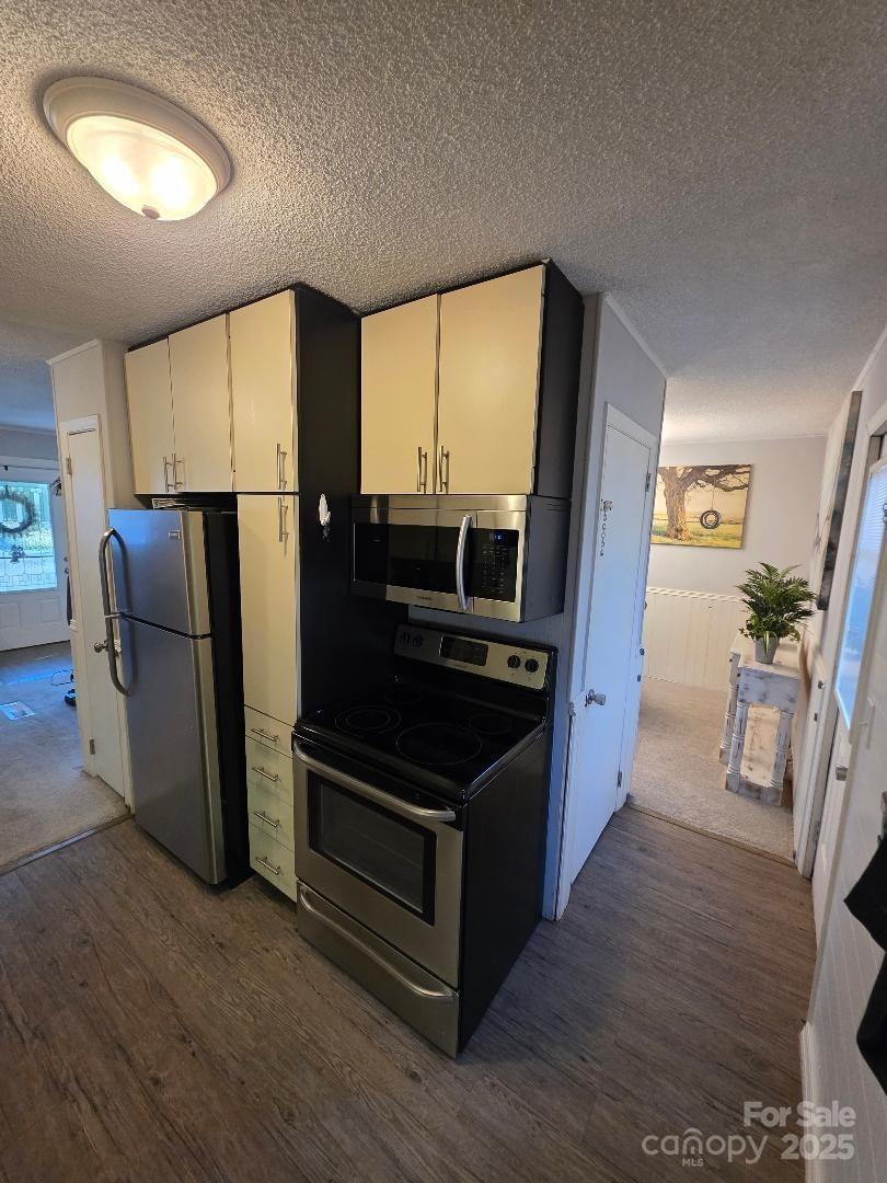 26 Azalea Road Arden, NC 28704 - Photo 16 of 26 a kitchen with stainless steel appliances a refrigerator and wooden floor