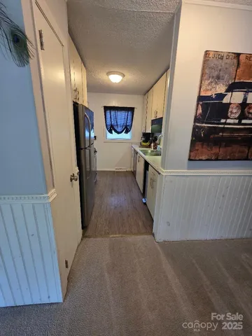 a kitchen with a sink cabinets and wooden floor