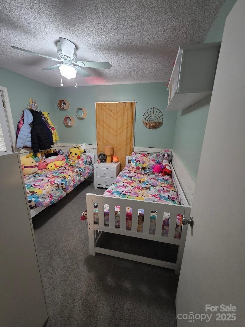 26 Azalea Road Arden, NC 28704 - Photo 21 of 26 a bed room with a bed and a dresser in it