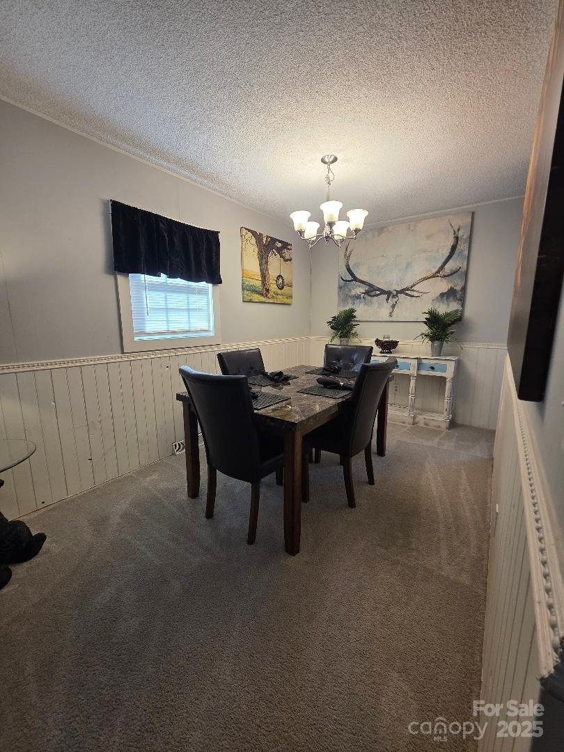 26 Azalea Road Arden, NC 28704 - Photo 23 of 26 a view of a dining room with furniture and chandelier
