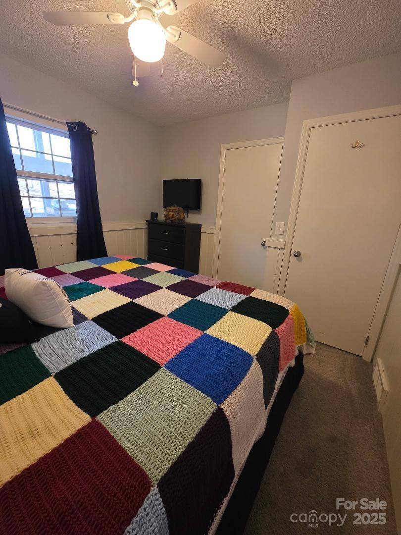 26 Azalea Road Arden, NC 28704 - Photo 24 of 26 a bedroom with a bed and wooden floor