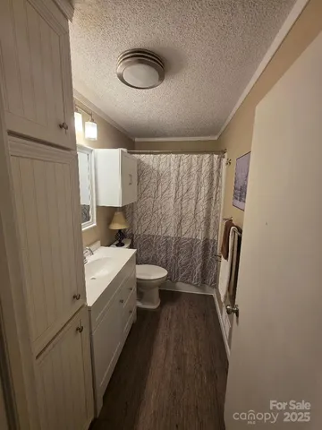 a bedroom with a bed and painting on the wall