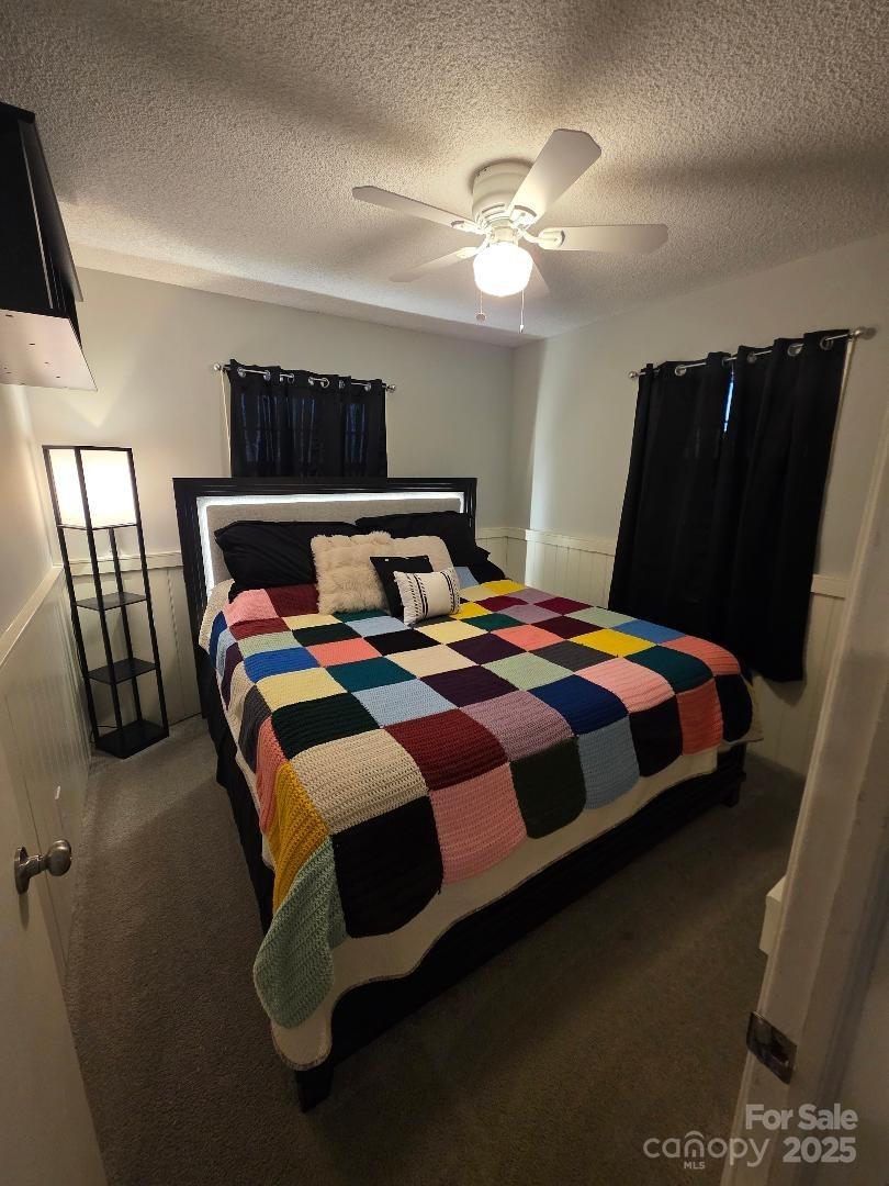 26 Azalea Road Arden, NC 28704 - Photo 26 of 26 a bedroom with a bed and painting on the wall