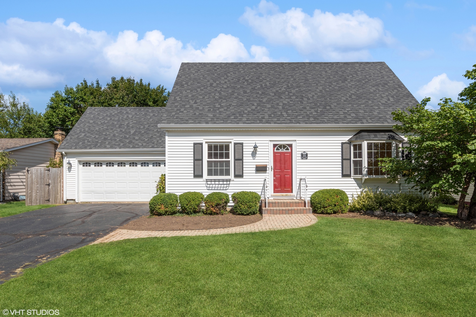 a front view of a house with a garden