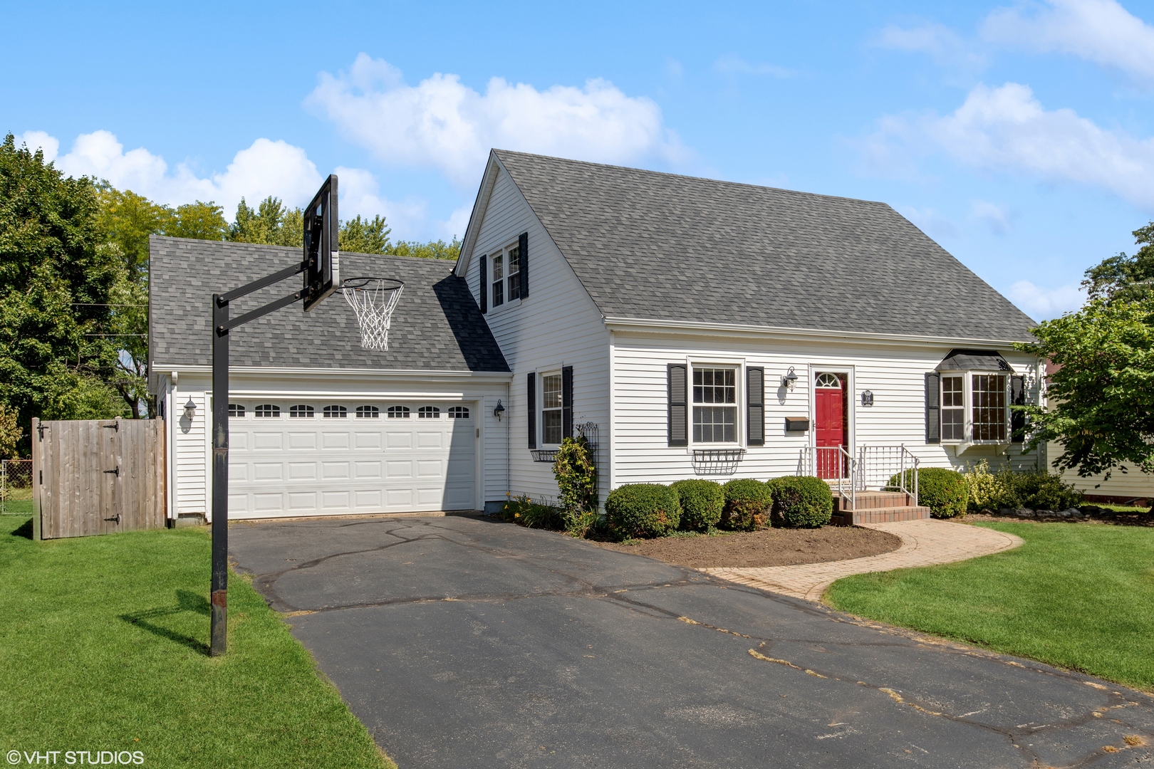 106 Lloyd Street Cary, IL 60013 - Photo 2 of 14 a front view of a house with a garden and plants