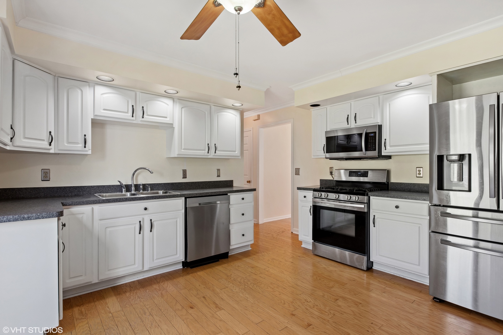 106 Lloyd Street Cary, IL 60013 - Photo 5 of 14 a kitchen with granite countertop a sink stainless steel appliances and cabinets