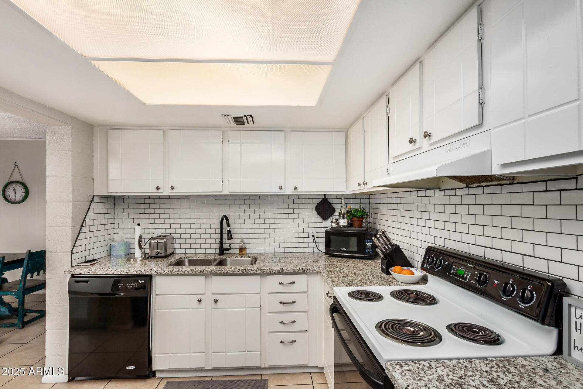 4201 East Camelback Road, Unit 15 Phoenix, AZ 85018 - Photo 12 of 32 a kitchen with a stove a sink and cabinets