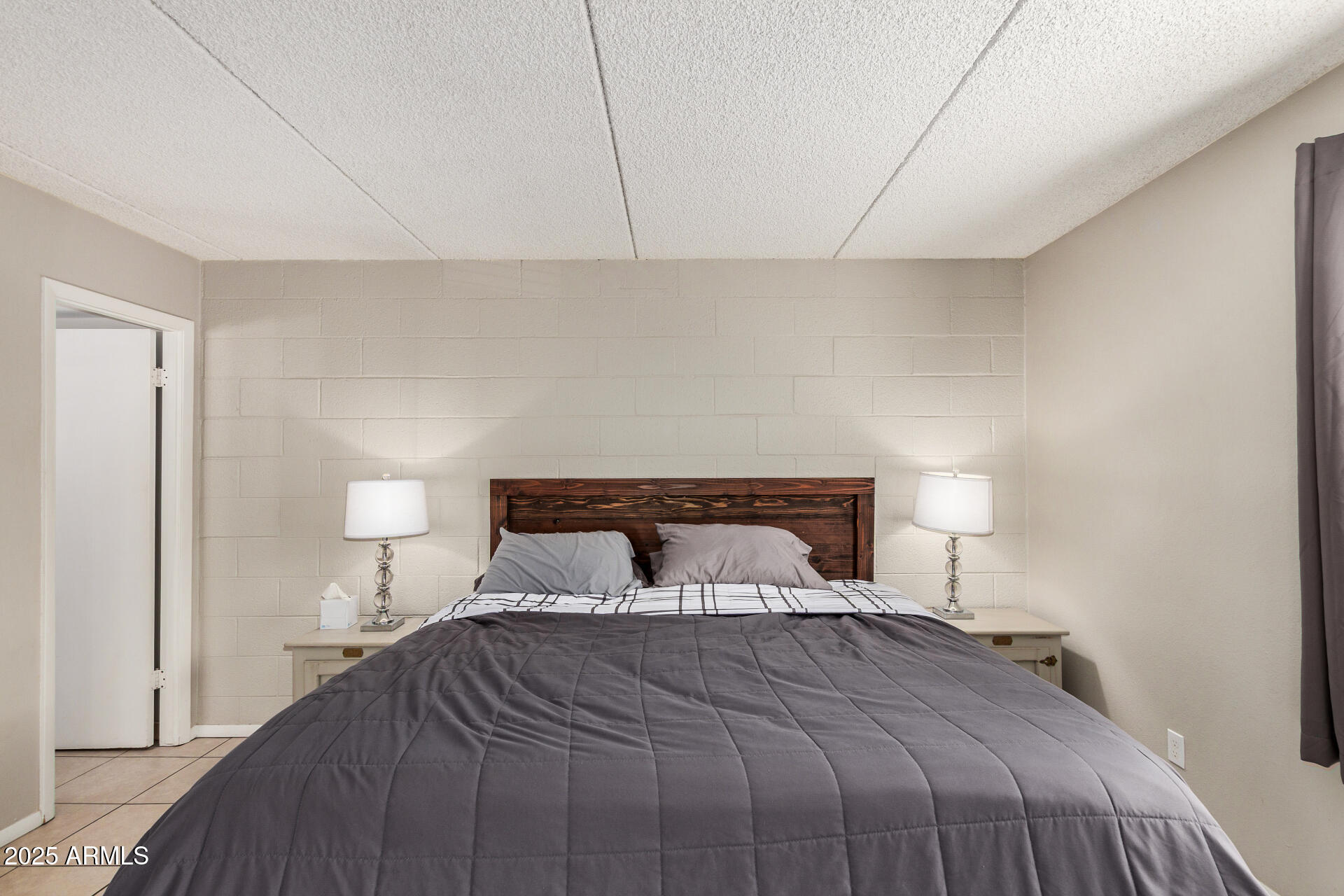 4201 East Camelback Road, Unit 15 Phoenix, AZ 85018 - Photo 14 of 32 a bedroom with a bed and a night stand