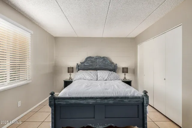 a bedroom with a bed and a window