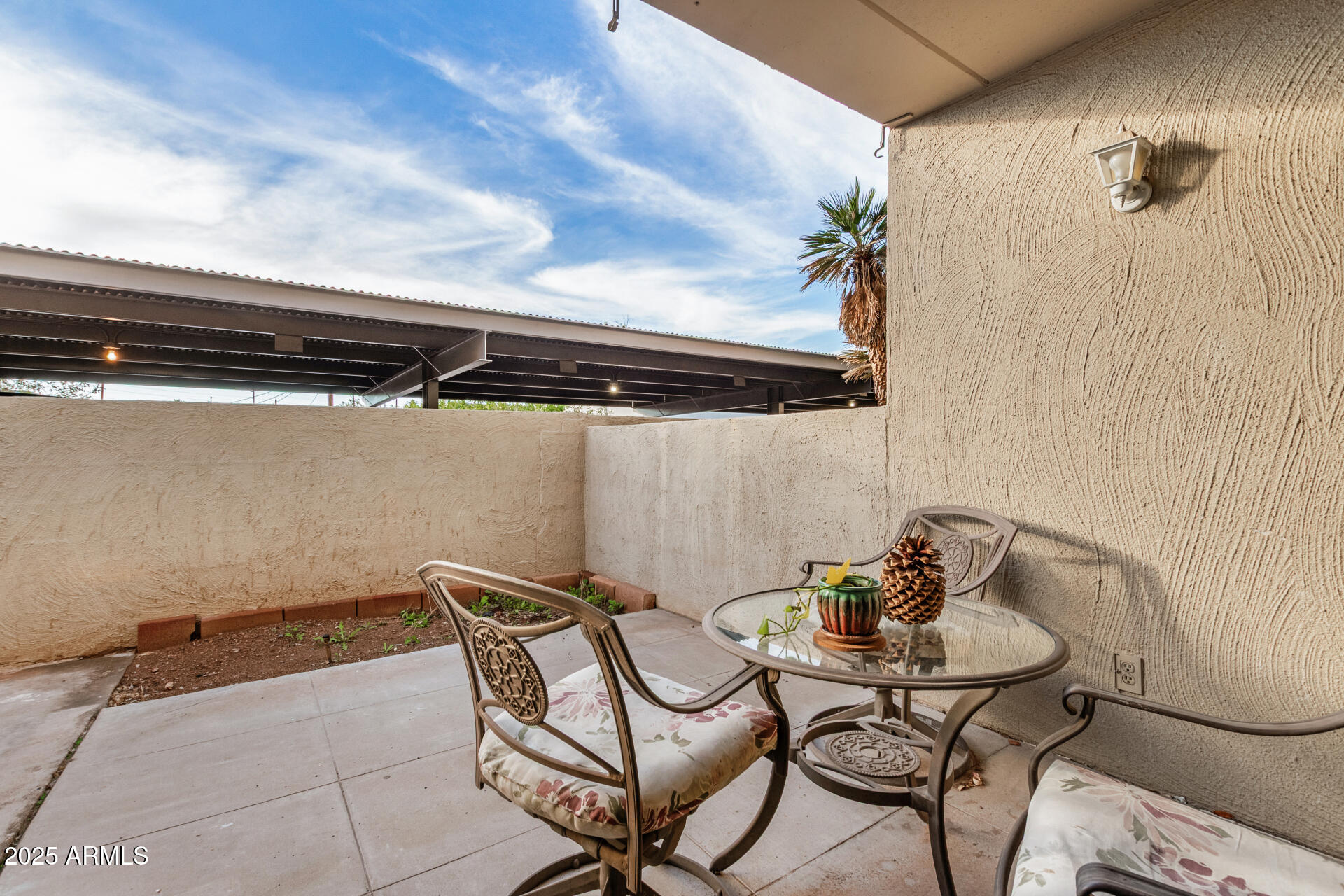 4201 East Camelback Road, Unit 15 Phoenix, AZ 85018 - Photo 24 of 32 a balcony with table and chairs