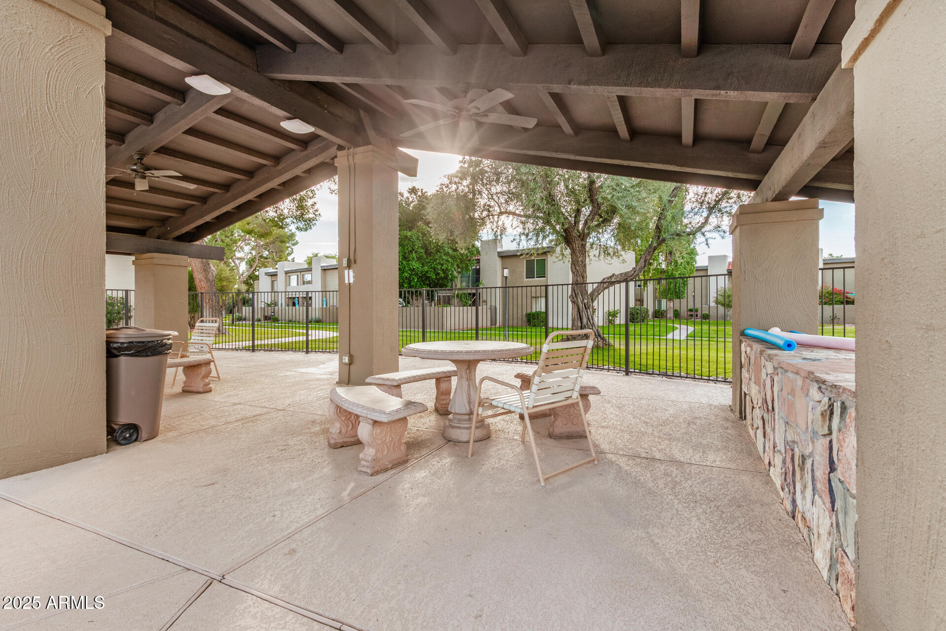 4201 East Camelback Road, Unit 15 Phoenix, AZ 85018 - Photo 29 of 32 a living room with patio furniture and a garden