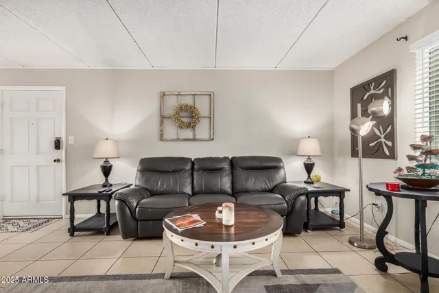 a living room with furniture a piano and a table