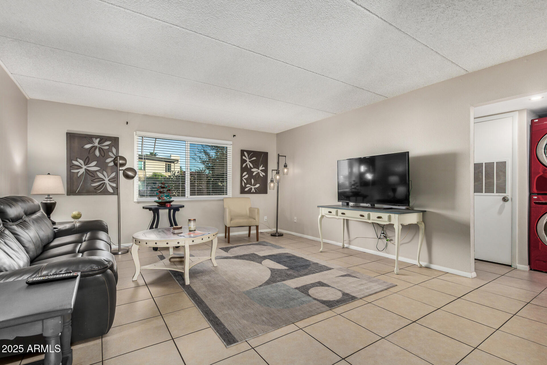4201 East Camelback Road, Unit 15 Phoenix, AZ 85018 - Photo 6 of 32 a living room with furniture and a flat screen tv