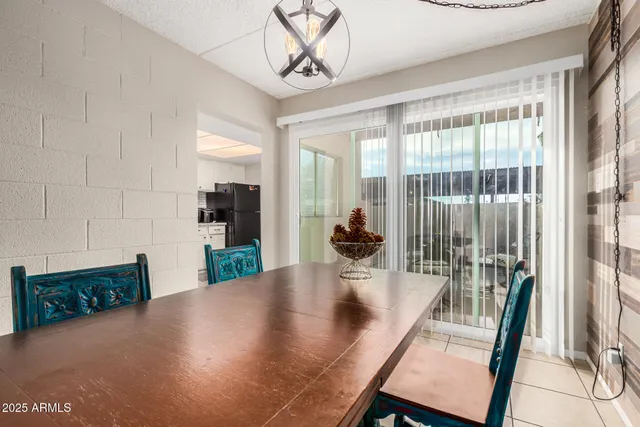 a view of a dining room with furniture and a floor to ceiling window