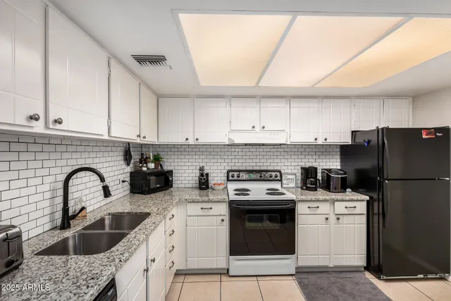 a kitchen with a sink a stove and refrigerator