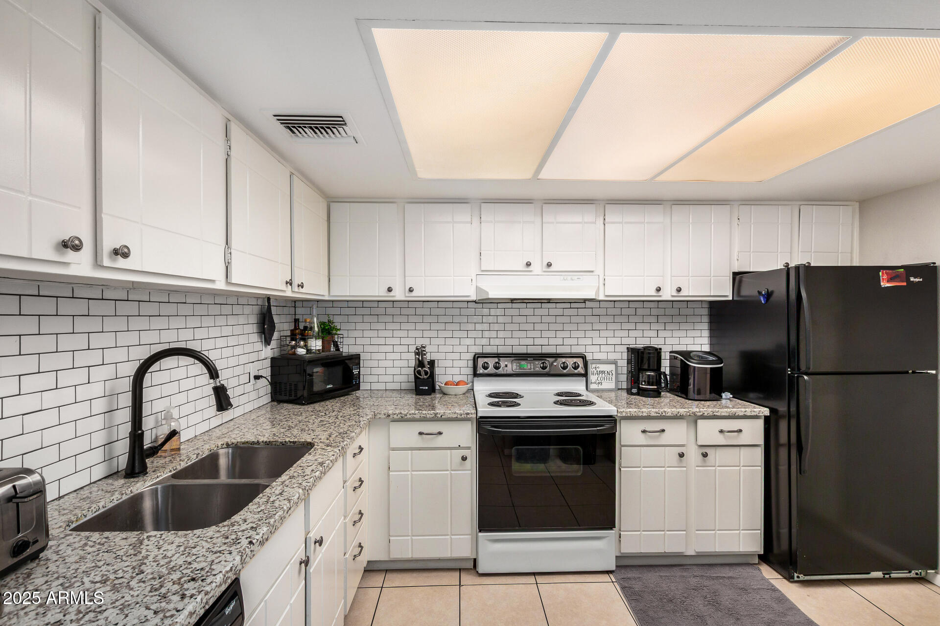 4201 East Camelback Road, Unit 15 Phoenix, AZ 85018 - Photo 10 of 32 a kitchen with a sink a stove and refrigerator