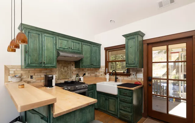 a kitchen with stainless steel appliances a table and chairs