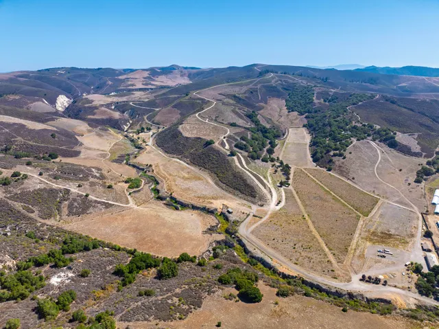 an aerial view of residential house and sandy dunes